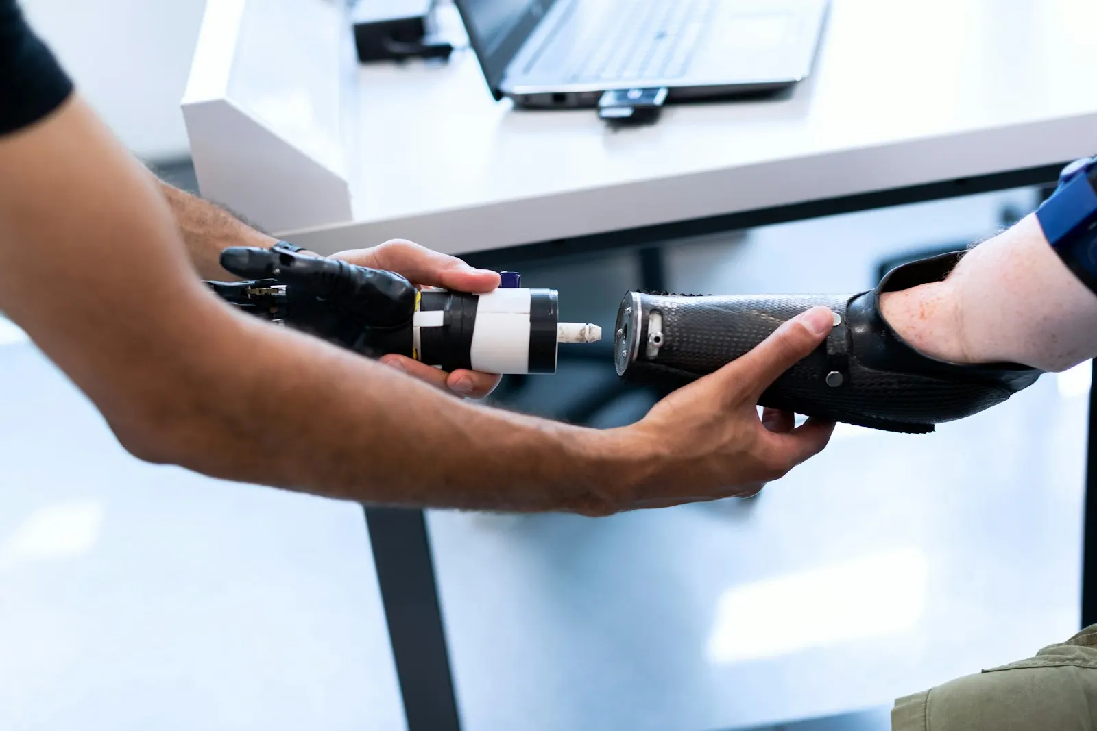 A prosthetic arm being connected and adjusted by a specialist